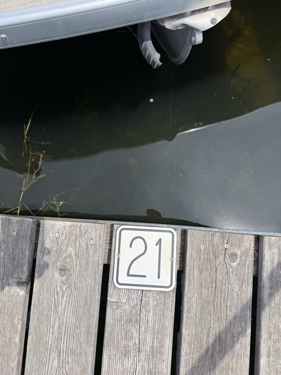 Slip number 21 placard on a weathered dock